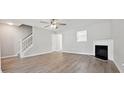 Bright living room features hardwood floors, a cozy fireplace, and a staircase at 1575 April Ln, Morrow, GA 30260