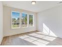 Bright bedroom showcasing three windows and hardwood floors at 2620 Mackintosh Ct # 19, Brookhaven, GA 30319
