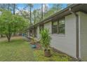 Side view of a beautifully maintained white brick house with green lawn and planted landscaping at 3658 Brock Rd, Duluth, GA 30096