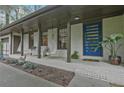 Charming front porch featuring modern blue door, swing chairs, and inviting curb appeal at 3658 Brock Rd, Duluth, GA 30096