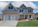 Inviting two-story home featuring a brick and siding exterior, attached two-car garage, and well-manicured lawn at 668 Crest Line Trl, Powder Springs, GA 30127