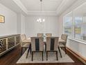 Bright dining room featuring tray ceilings, a large window, and a modern table with seating for six at 1395 Crestwind Nw Rd, Kennesaw, GA 30152