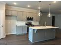 Modern kitchen with an island, pendant lighting, stainless steel appliances, and ample storage at 3908 Shelleydale Dr, Powder Springs, GA 30127