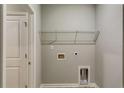 Functional laundry room with shelving and utility connections at 3908 Shelleydale Dr, Powder Springs, GA 30127