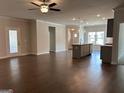 Open-concept living area with hardwood floors and modern lighting fixtures at 3908 Shelleydale Dr, Powder Springs, GA 30127
