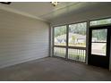 Relaxing covered porch with screened windows overlooking the property's landscape at 3908 Shelleydale Dr, Powder Springs, GA 30127