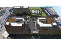 An aerial view showcasing the multi-building development with parking, street access, and patio areas at 120 N Main St # 2A, Alpharetta, GA 30009