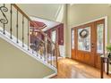 Grand foyer showcasing hardwood floors, a decorative staircase, and an elegant front door at 1455 Oglethorpe Run Ln, Suwanee, GA 30024