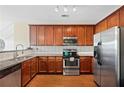 Well-appointed kitchen featuring stainless steel appliances, granite countertops, and rich wood cabinetry at 3065 Windcrest Ct, Alpharetta, GA 30022