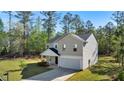A charming two-story home featuring a two-car garage, a well-kept lawn, and beautiful landscaping at 15 Sloane Ct, Covington, GA 30016