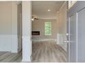Inviting entryway featuring hardwood floors and an open view into the living room, complete with an electric fireplace at 1097 Bodega Loop, Locust Grove, GA 30248