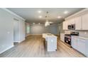 Spacious kitchen with stainless steel appliances, quartz counters, and an open living area at 3871 Shelleydale Dr, Powder Springs, GA 30127
