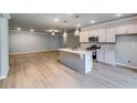 Open-concept living room and kitchen with stainless steel appliances and ample natural light at 3871 Shelleydale Dr, Powder Springs, GA 30127