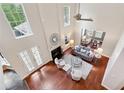 A spacious living room with high ceilings, a cozy fireplace, lots of natural light and beautiful hardwood floors at 310 Kingspring Ct, Roswell, GA 30076