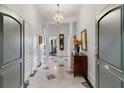 Elegant condo foyer with tiled floor, a chandelier, and classic architectural details at 3101 Howell Mill Nw Rd # 301, Atlanta, GA 30327
