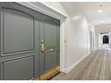 Condo gray double doors featuring brass hardware and an entry hallway with neutral carpet at 3101 Howell Mill Nw Rd # 301, Atlanta, GA 30327