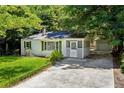 Cozy home with a screened in porch, attached garage, and mature trees at 4742 West Dr, Forest Park, GA 30297