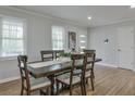 Bright dining room with hardwood floors, a modern light fixture, and ample natural light at 1590 Arden Sw Dr, Marietta, GA 30008