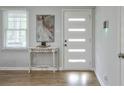 Modern entryway featuring a stylish white door with translucent panes and a decorative table at 1590 Arden Sw Dr, Marietta, GA 30008