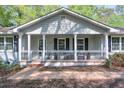 Inviting covered front porch with decorative columns and black metal railings at 1590 Arden Sw Dr, Marietta, GA 30008