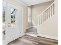 Light-filled entryway with glass door, staircase, and wood-look flooring at 1125 Reunion Pl, Atlanta, GA 30331