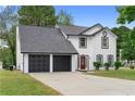 A charming two-story home has a well-manicured lawn and a two-car garage at 1125 Reunion Pl, Atlanta, GA 30331