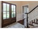 Inviting foyer with hardwood floors, glass paned front door, and a staircase at 1991 River Forest Dr, Marietta, GA 30068