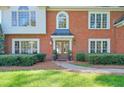 Elegant brick home featuring a covered front entry and manicured landscaping at 1991 River Forest Dr, Marietta, GA 30068
