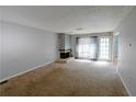 Cozy living room with stone fireplace and large window providing ample sunlight at 4964 N Ellipse Dr, Marietta, GA 30068