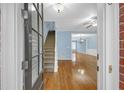 Inviting foyer with hardwood floors leading into a light-filled living space and view of staircase at 6206 Carriage Gate Se Ln # 6, Mableton, GA 30126