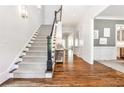 Elegant foyer showcasing hardwood floors, a staircase with a decorative runner, and sophisticated decor at 156 Lake Forrest Ne Ln, Atlanta, GA 30342