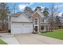 Charming two-story home boasting stone accents, a manicured lawn, and a two-car garage at 9429 Golfview Pt, Villa Rica, GA 30180