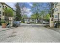 Community gated entrance with brick paved drive, security cameras, and controlled access at 955 Juniper St # 3026, Atlanta, GA 30309