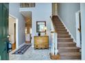 Inviting foyer with staircase, light gray walls, neutral tile floors, and wood accents at 9600 Poplar Ct, Douglasville, GA 30135