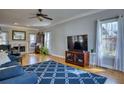 Bright living room with hardwood floors, large windows, and a cozy fireplace at 9600 Poplar Ct, Douglasville, GA 30135