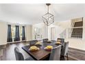 Dining room featuring modern chandelier, hardwood floors, and natural light at 1318 Avington Glen Dr, Lawrenceville, GA 30045