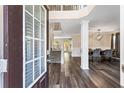 Inviting foyer with hardwood floors, white columns, and elegant dining room at 1318 Avington Glen Dr, Lawrenceville, GA 30045