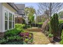 Lush backyard featuring an amazing landscape with a retaining wall and garden for flowers at 2235 Chestnut Pass, Decatur, GA 30033