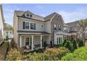 Attractive two-story home with a mix of brick and siding, enhanced by a covered porch and manicured landscaping at 2235 Chestnut Pass, Decatur, GA 30033