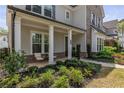 Inviting front porch with elegant columns and cozy seating area, surrounded by lush, manicured landscaping at 2235 Chestnut Pass, Decatur, GA 30033