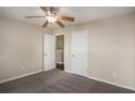 Inviting bedroom with neutral colors, a ceiling fan, and two doors to other rooms at 3459 Village Park Sw Ln, Atlanta, GA 30331
