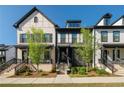 Beautiful townhomes with brick and siding exteriors, showcasing manicured lawns and inviting front entrances at 938 Catamaran Ct, Alpharetta, GA 30005