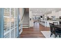 Bright foyer with hardwood floors, showcasing an open floor plan with staircase, kitchen and living area at 938 Catamaran Ct, Alpharetta, GA 30005