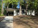 Charming single-story white home with a black trim, car port, and a front porch with black railings at 2804 Dearwood Sw Dr, Atlanta, GA 30315
