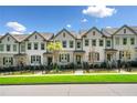 Desirable street view of pristine townhomes with neutral siding and manicured front yards at 309 Vista Ln, Woodstock, GA 30189