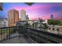 Balcony view with wrought iron railing overlooking city skyline at sunset at 3481 Lakeside Ne Dr # 907, Atlanta, GA 30326