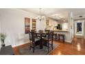 Dining room with wood floors, a round table, and view into the kitchen with barstool seating at 408 Brighton Pt, Atlanta, GA 30328