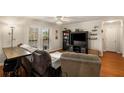 Comfortable living room with hardwood floors, a ceiling fan, and access to the balcony at 408 Brighton Pt, Atlanta, GA 30328