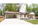 Renovated ranch home featuring an attached carport and a freshly painted brick exterior at 4506 Dorset Dr, Decatur, GA 30035