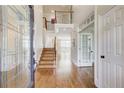 Inviting foyer with hardwood floors, a staircase, and an open view to the living space at 1900 Denton Walk Ct, Marietta, GA 30062